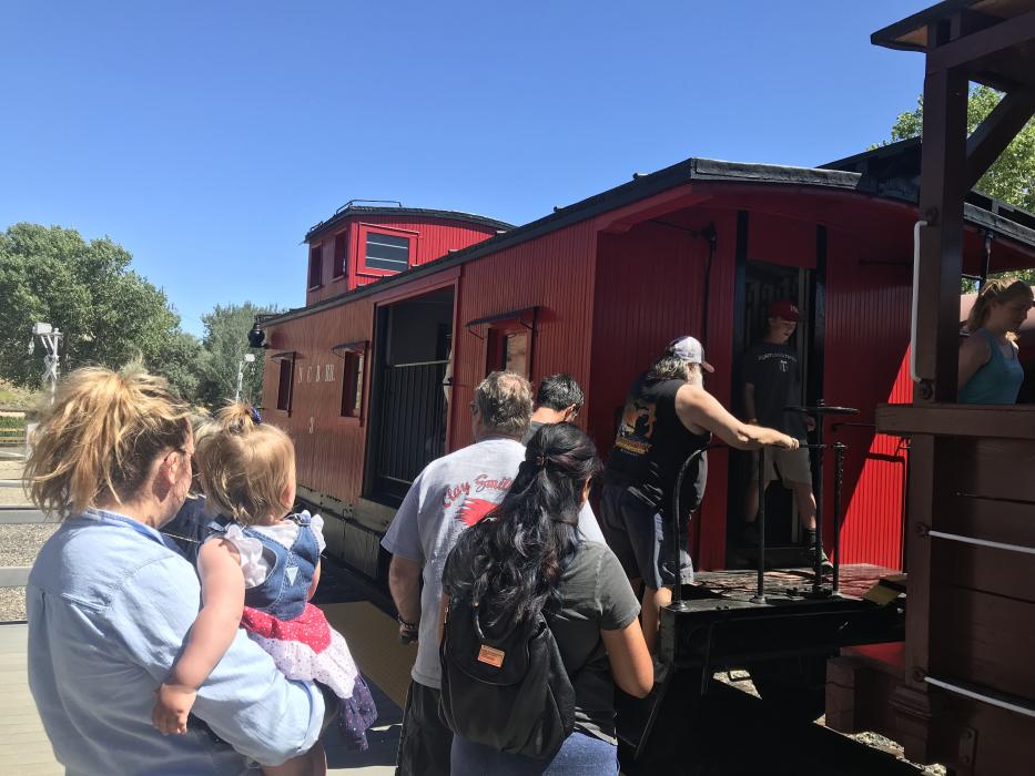 Passengers in line to load the caboose.