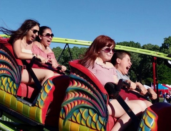 Riders enjoy the thrill of a roller coaster Saturday.