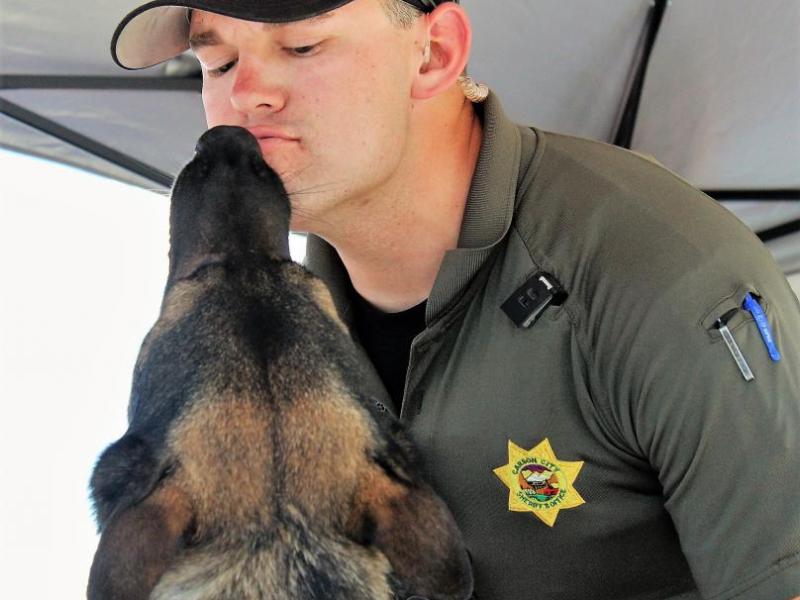 Photos by Brett Fisher. K-9 Ivo gives kisses to his handler, CCSO Deputy Brett Bindley.