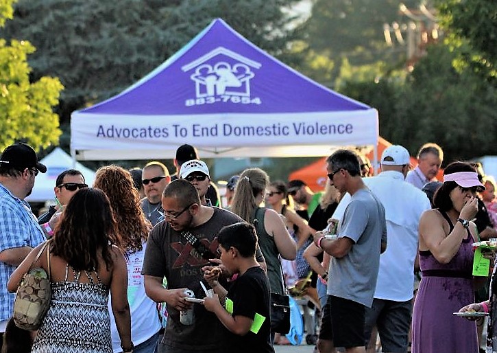 Photo by Brett Fisher. Advocates to End Domestic Violence information tent at the 2017 Taste of Downtown.