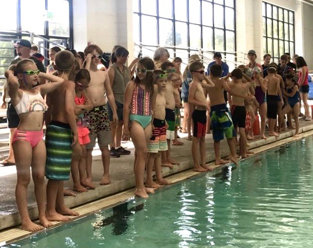 Swimmers were required to complete two laps around the marked area of the pool in their first event.