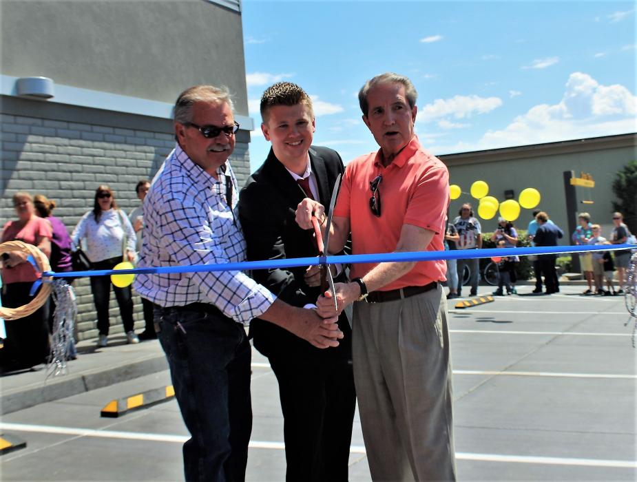 Photos by Brett Fisher. Bob Fredlund, left, Clayton Burns and Carson City Mayor Bob Crowell cut the ribbon Saturday.