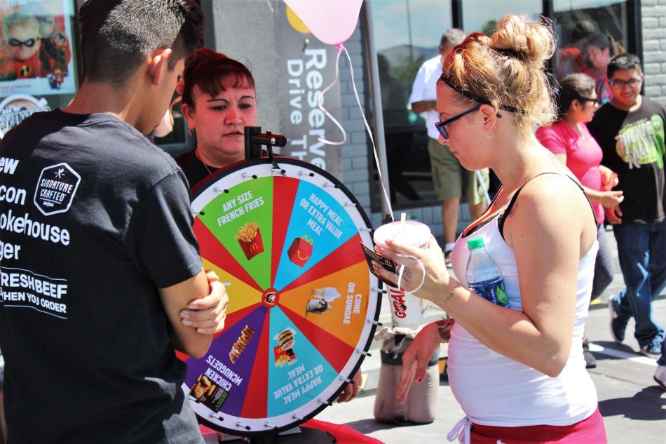 Customers spin the prize wheel Saturday morning.