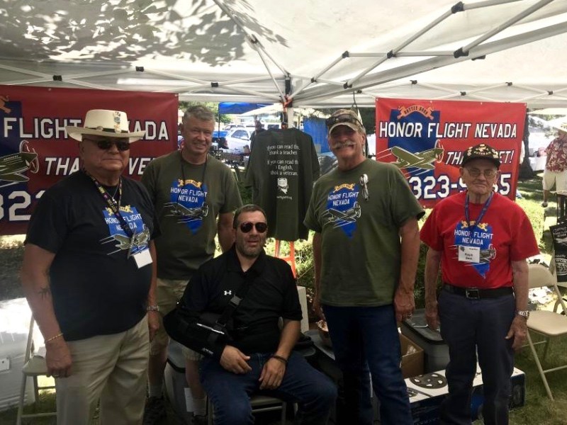 Honor Flight Nevada CEO Jon Yuspa (seated) with veterans at the High Sierra chili cook-off.