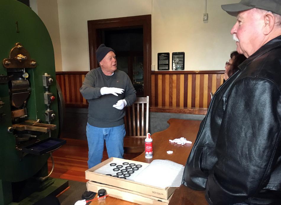 Nevada State Museum volunteer Cliff Dunseth talks about the history of Coin Press No. 1 to museum visitors.