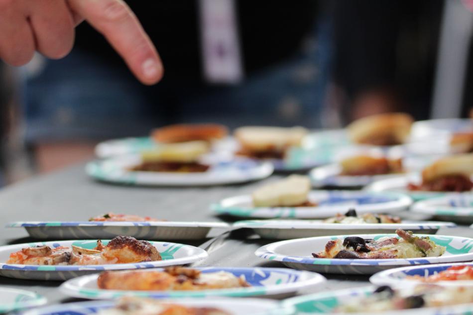 A Taster points at pizza slices.