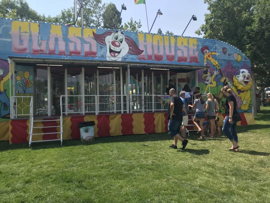 A group of carnival-goers waits for the fun house.