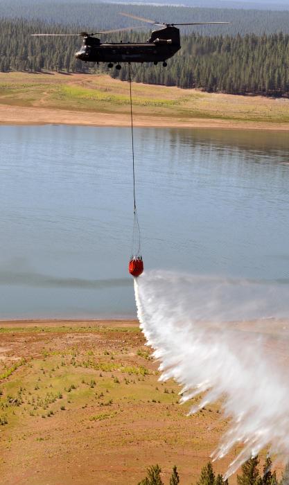 A Nevada Army Guard CH-47 Chinook helicopter demonstrates a 2000-gallon water bucket drop during training at Stampede Reservoir.