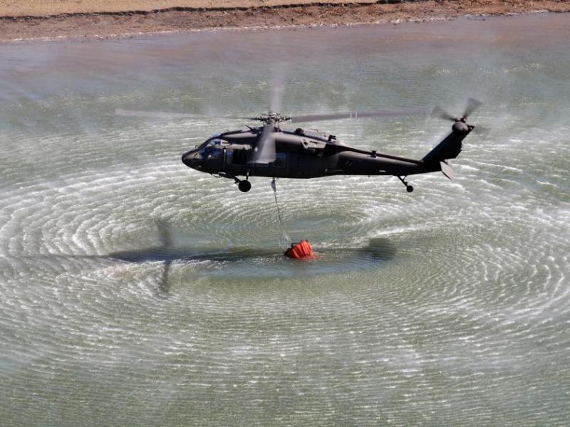 A Nevada Army Guard UH-60 Black Hawk fills its 660-gallon water bucket during training at Stampede Reservoir.
