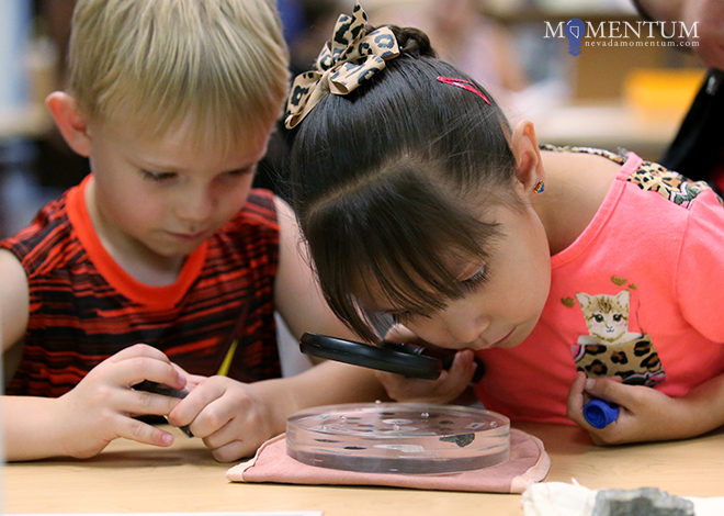 Tristan Hansen, 5, left, and Payton Lopez, 7, check out lunar rock and meteorite samples. Cathleen Allison, Nevada Momentum