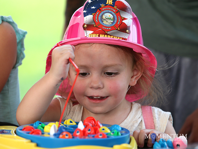 Roulette Nicole Patellos, 2, plays a fishing game at the DARE booth. Cathleen Allison, Nevada Momentum