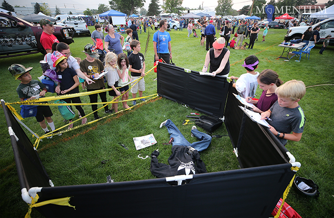 Kids try to solve a mock crime scene at the CCSO Investigations and Crime Lab booth. Cathleen Allison, Nevada Momentum