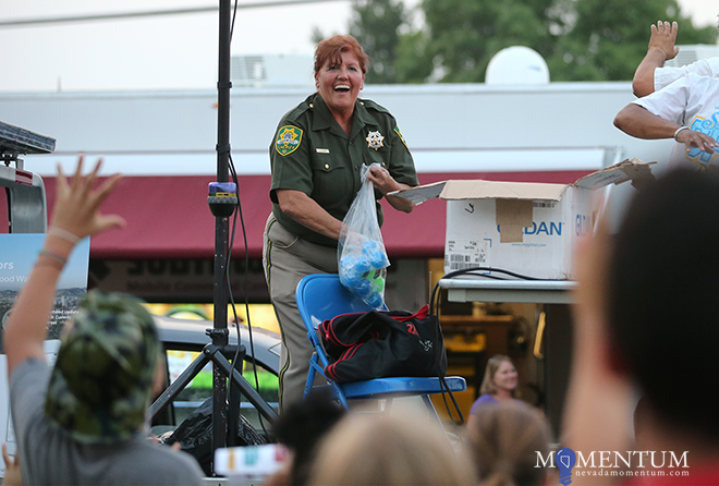 Carson City Sheriff’s DARE Officer Lisa Davis throws collectible items from the stage. Photo: Cathleen Allison, Nevada Momentum
