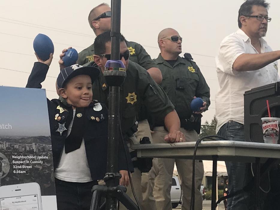 A strong little guy helps deputies out with t-shirt crowd tossing.