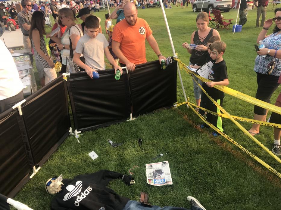 An active crime scene investigation was underfoot during festivities. Lead detective shown with clipboard.