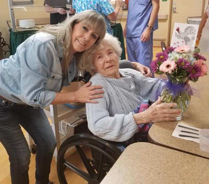 Lori Morris, founder of Angels with Flowers, makes the 100th floral donation of 2018 at Carson Nursing and Rehabilitation.