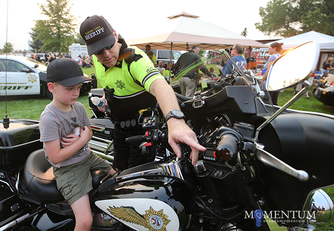 Carson City Sheriff’s Sgt. Earl Mays shows Chayson Schierholt, 5, his motor unit.