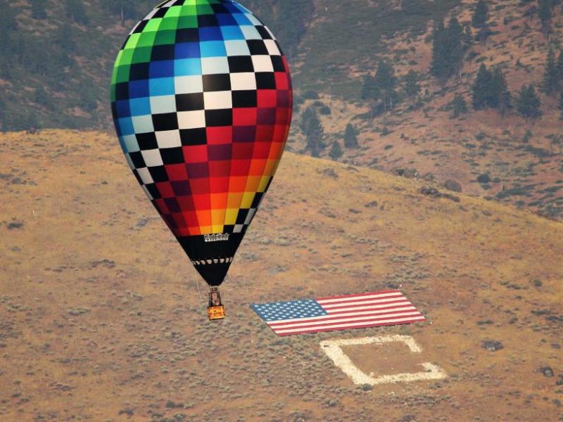 Photos by Brett Fisher. A racing hot air balloon floats by C Hill Saturday morning.