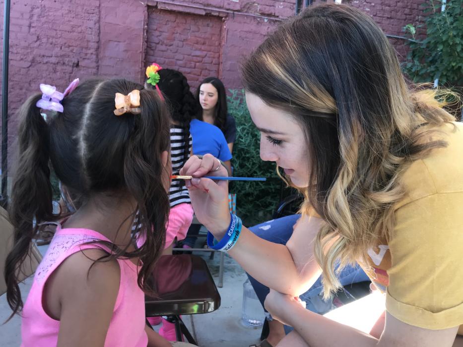Face painting was in high demand with high school volunteers taking requests from young students.