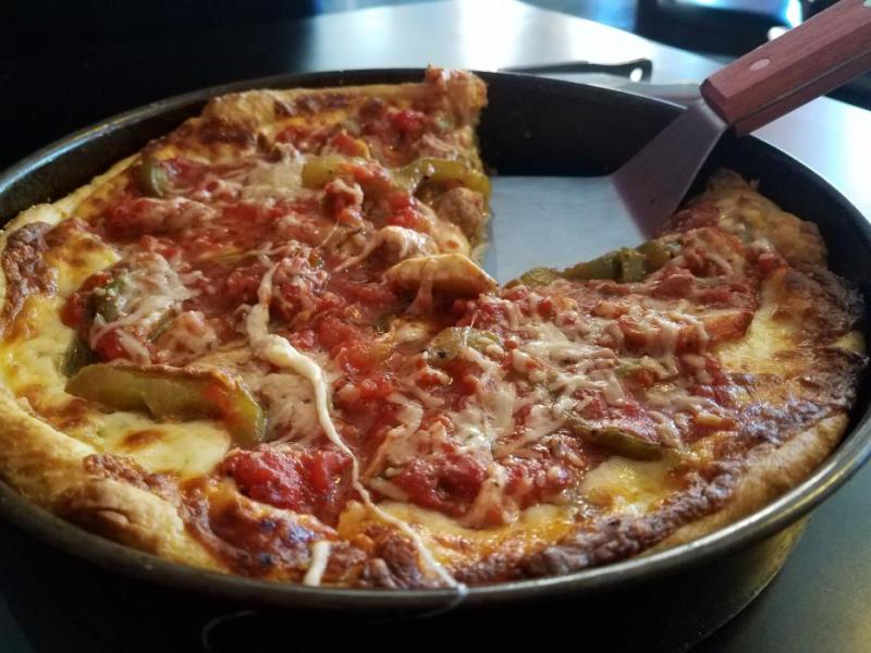 Photos by Brett Fisher. Traditional Chicago deep dish pizza with Italian sausage, mushrooms and peppers.