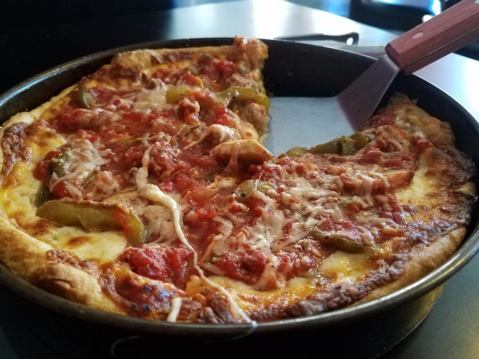 Photos by Brett Fisher. Traditional Chicago deep dish pizza with Italian sausage, mushrooms and peppers.
