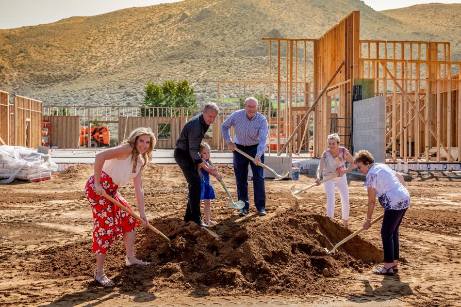 Team members pose with shovels during Friday's groundbreaking ceremony.