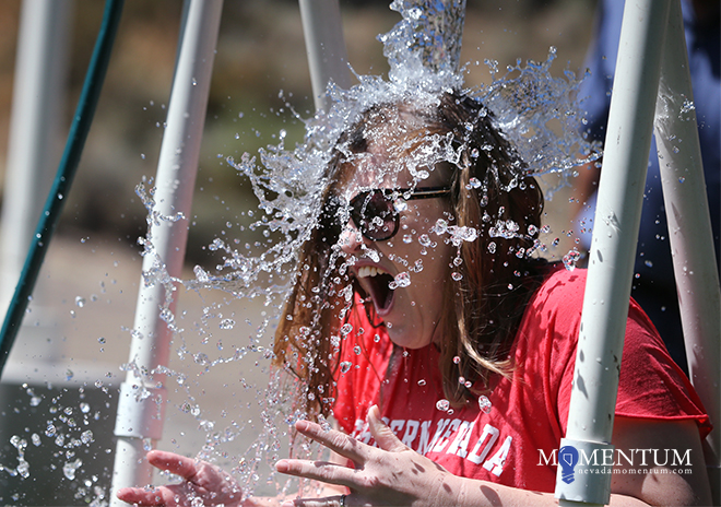 Photos by Cathleen Allison/Nevada Momentum. WNC English Professor Geri Pope gets soaked during the ASWN BBQ Aug. 30.