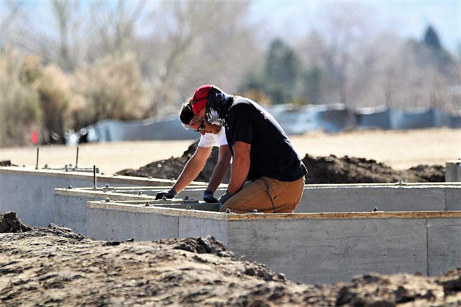 Photo by Brett Fisher. Construction workers on a job site in the Silver Oak Golf Course development.
