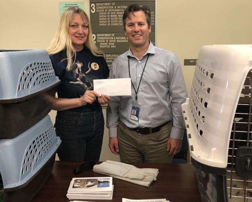 Suzette Feilen with WAIF was presented with a $600 donation raised by employees at NDCNR.