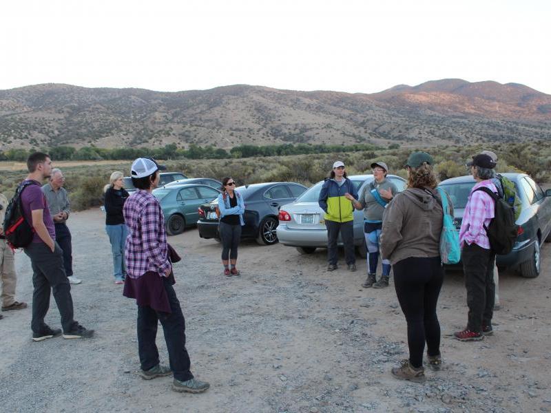 Volunteer Coordinator Chelsea Kincheloe is giving an overview of the hike they will soon start.