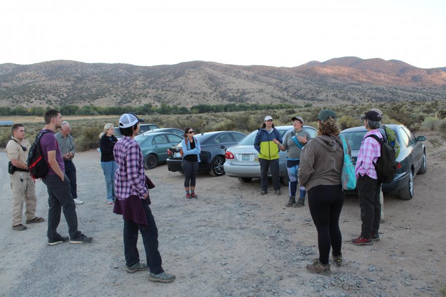 Volunteer Coordinator Chelsea Kincheloe is giving an overview of the hike they will soon start.