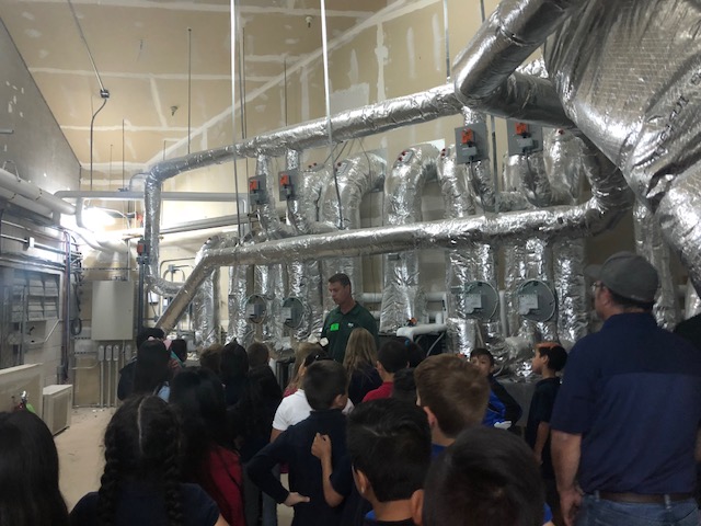 Students at Mark Twain Elementary School tour the area of the HVAC system at their school.