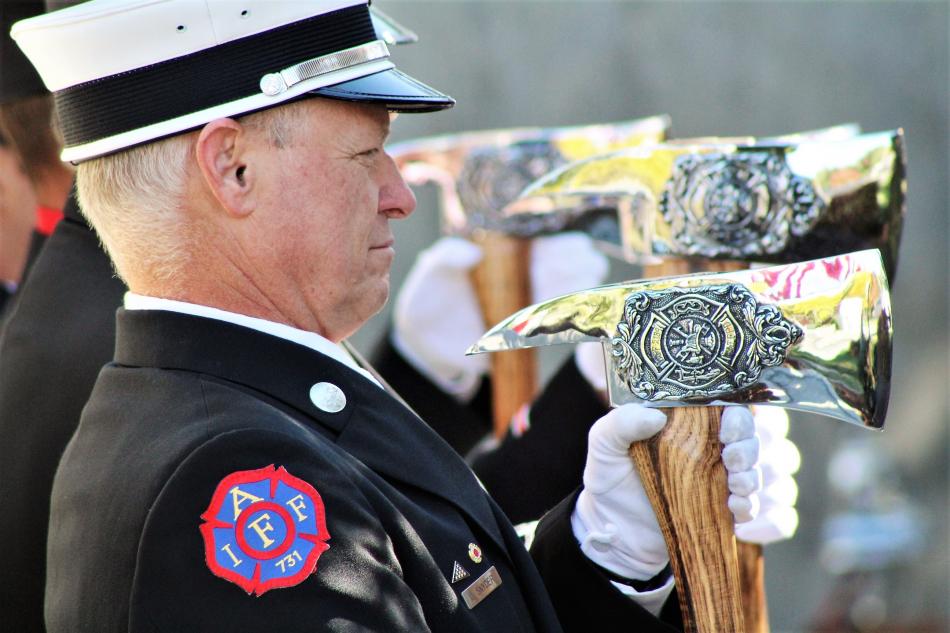 Honor guard members holding ceremonial axes Saturday during the Pledge of Allegiance.