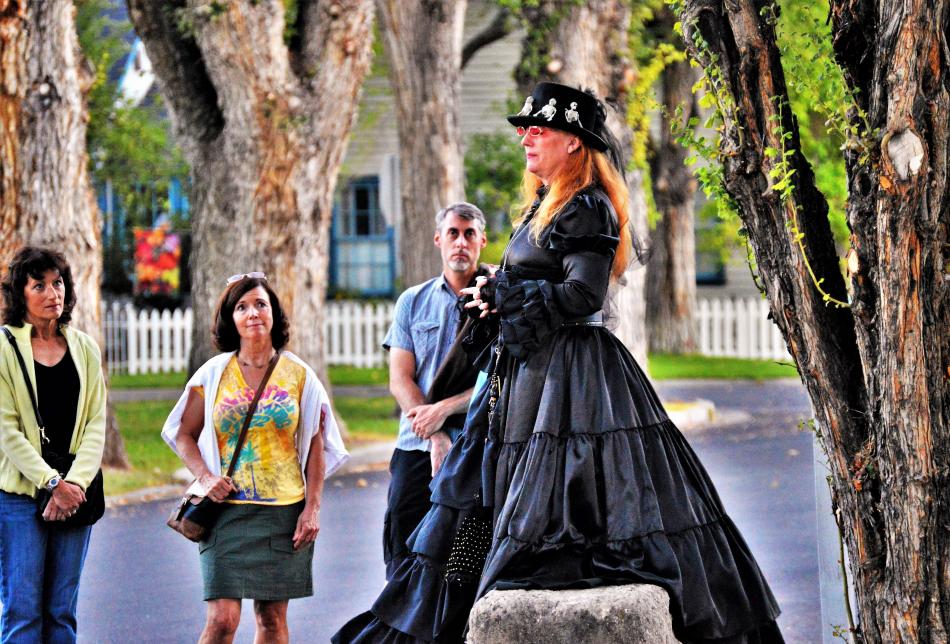 Photo by Brett Fisher. Madame Curry, played by Mary Bennett, tells a ghost story in front of the Ormsby-Rosser House.