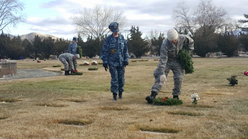 Several volunteers placed wreaths on veterans’ graves in December 2017 at Lone Mountain cemetery. Photo by Isaiah Burrows