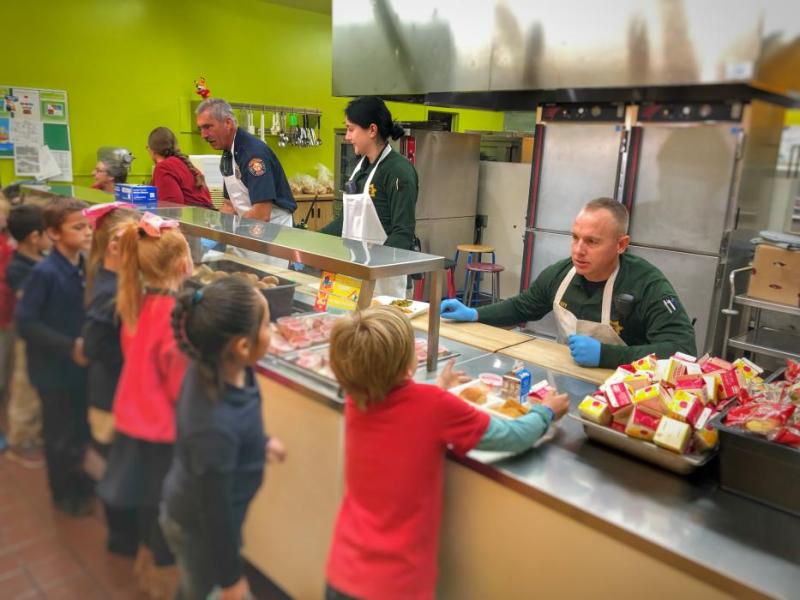 Carson City Fire Department, Sheriff’s Office and School Resource Officers serve up lunch Thursday at Seeliger Elementary.