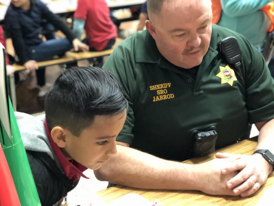 Carson City Sheriff's Office Deputy Jarrod Adams with Seeliger Elementary School Kindergartner Matt Luna Mora.