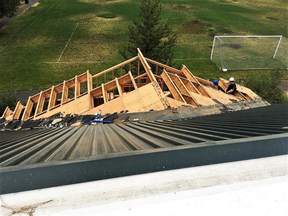 Kahle Community Center roofline in various stages of reconstruction.