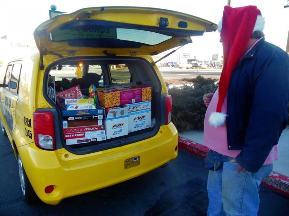 Photo by Brett Fisher. Mark Shepler stands next to his cab full of toys in Dec. 2016.