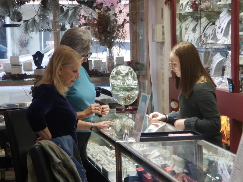 Photo by Brett Fisher. Shoppers look at jewelry inside Carson Jewelry and Loan Saturday.