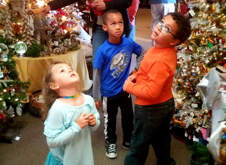 Photo by Brett Fisher. From left: Jade Belville, 4, Isaiah Sebring-Smith, 7, and Skylar Easley, 8, at Greenhouse Garden Center.