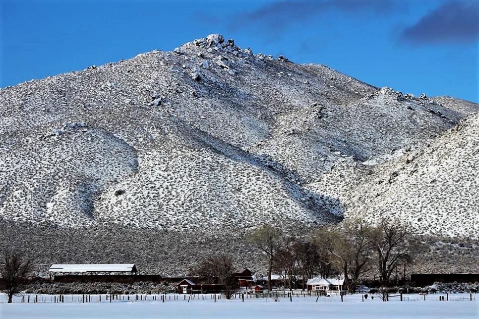 Photo by Brett Fisher. Silver Saddle Ranch sits below Prison Hill in a snowy scene.