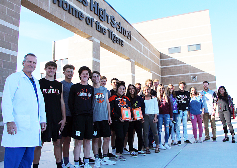 Jim Gocke and Nita Schwartz presented athletes at Douglas High School with a pair of new AED devices on Tuesday afternoon.