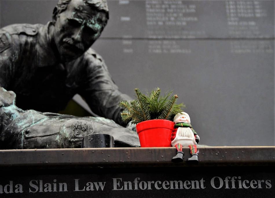 Photo by Brett Fisher. A snowman and potted tree decorate the Nevada Law Enforcement Officers Memorial in Carson City.
