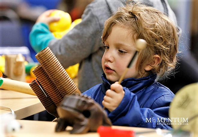 Isaac Slimak, 3, explores a musical instrument Saturday at the Carson City Library.
