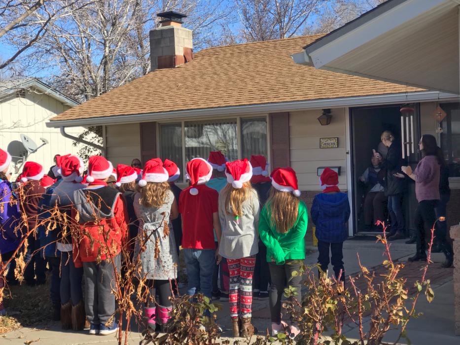 Sue Jesch listens to the Carson Montessori concert in front of her Carson City home Wednesday.
