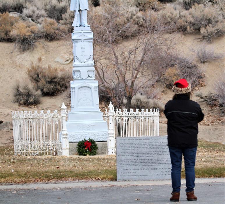 A volunteer pauses at the Nevada Civil War veterans memorial at Lone Mountain Cemetery.