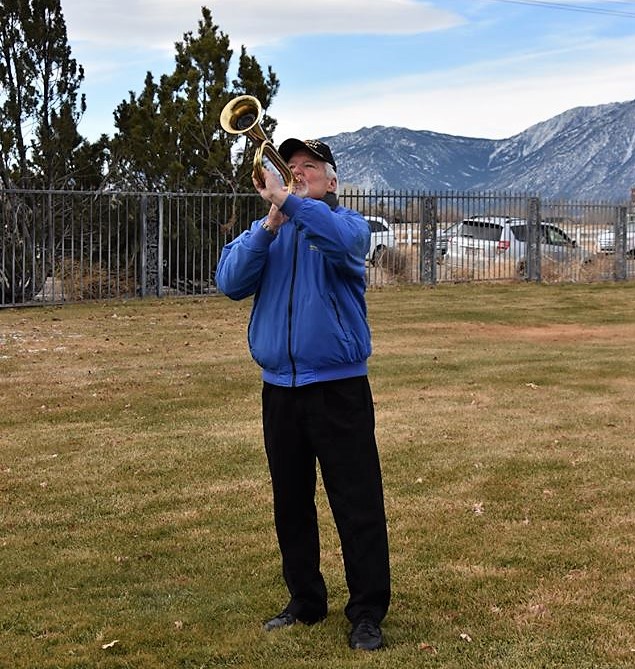 A bugler plays Taps during Saturday's ceremony.