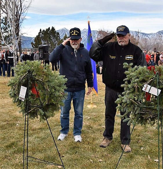 Veterans salute the Christmas wreath for fallen brethren.