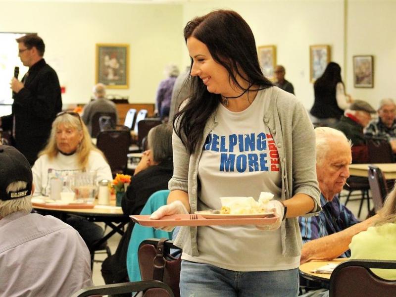 Greater Nevada Credit Union employees volunteer in the Carson City Senior Center dining room.